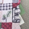 caleb-quilted-reversible-maroon-red-green-tan-plaid-wildlife-pine-cone-evergreen-dining-textiles-swatches
