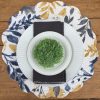 natural-home-navy-mustard-and-charcoal-reversible-round-quilted-place-mat-with-a-charcoal-cloth-napkin-and-farmhouse-greenery