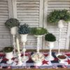 assorted-aged-patina-holders-on-patriotic-table-runner