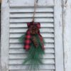 pine spray greenery with a buffalo check ribbon winter decor