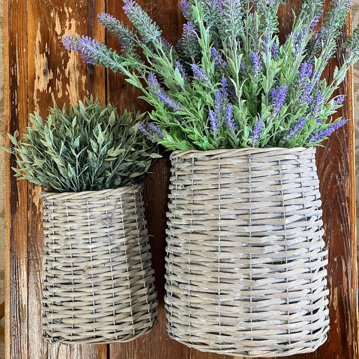 Set of 2 Woven Willow Baskets in 2 sizes, displayed with greenry and lavender