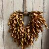 Sienna Hollow Faux Foliage Heart Shaped Wreath on Shiplap